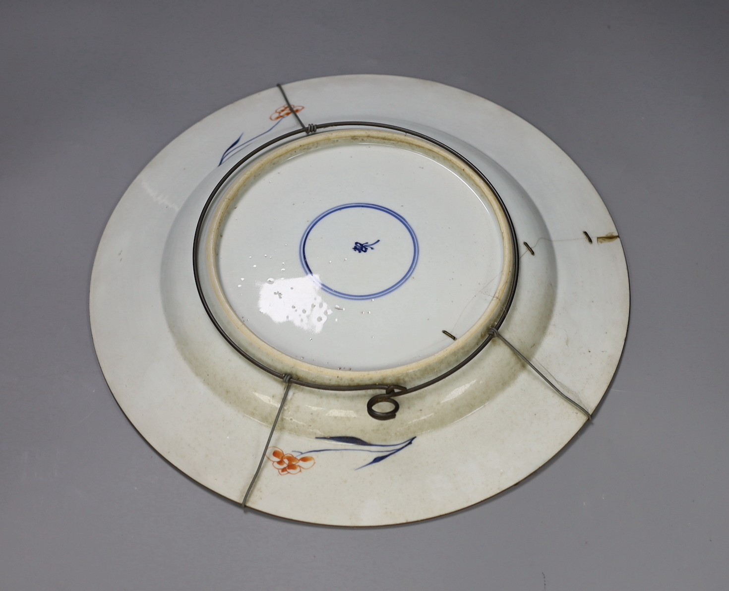 A pair of Chinese Imari dishes, Kangxi period, on wooden stands, 31 cms diameter., Provenance - D.C.Monk & Son, former dealers based in Kensington Church Street, London W8